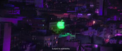 a green light on top of a building in a city