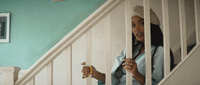 a woman standing on a stair case holding a banana