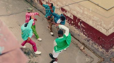 a group of young men dancing on the street