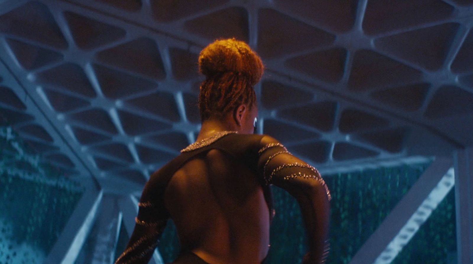 a woman in a futuristic space setting with her back to the camera