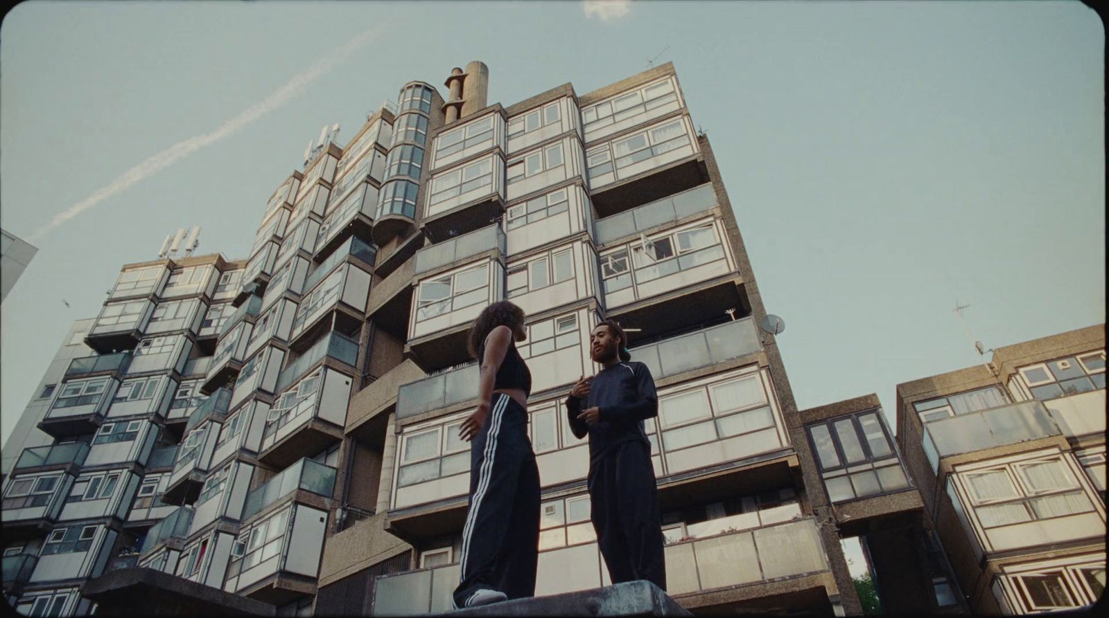 two people standing in front of a tall building