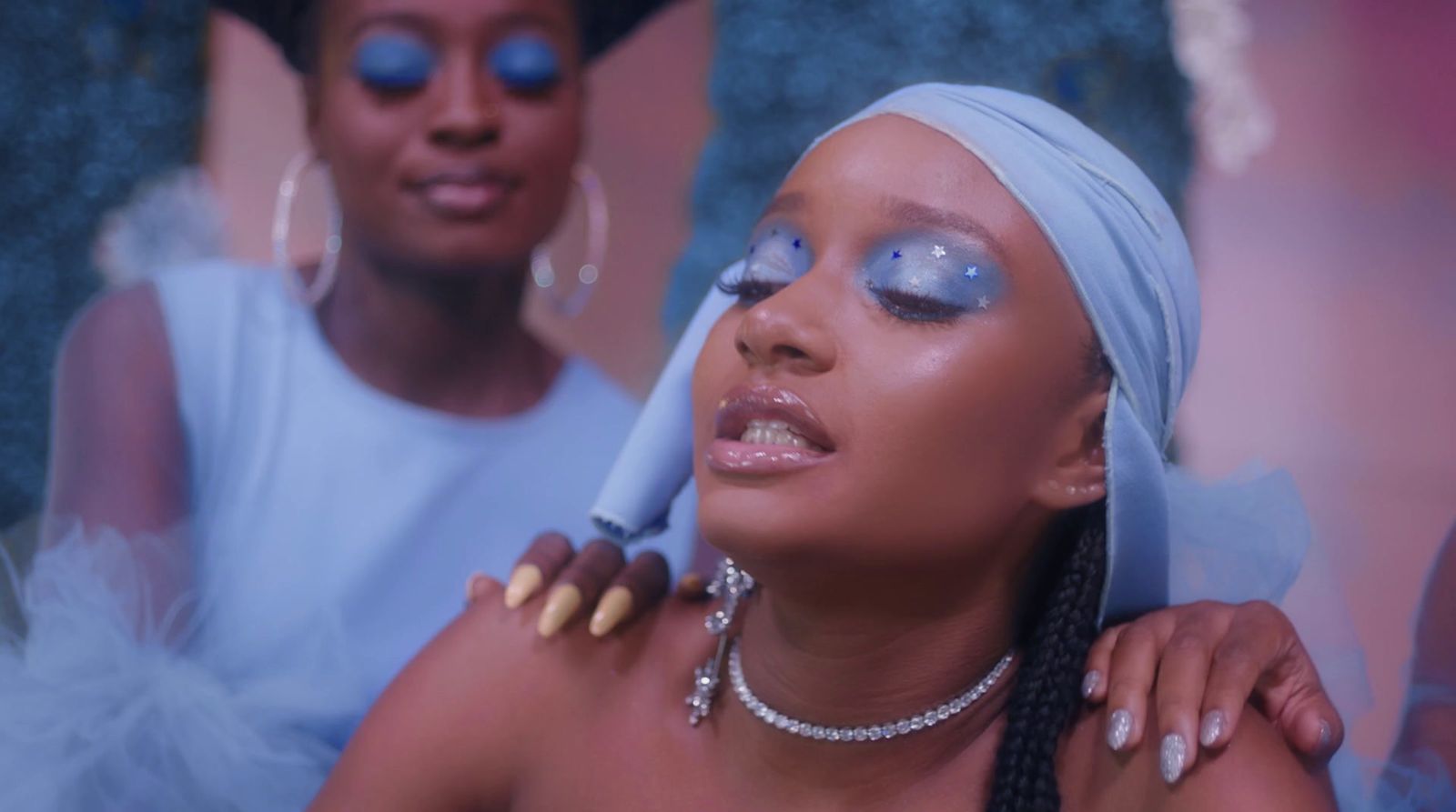 a woman with blue makeup and a white turban