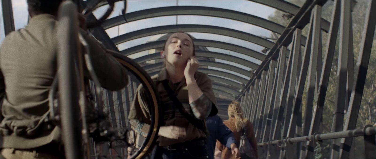 a group of people walking across a bridge