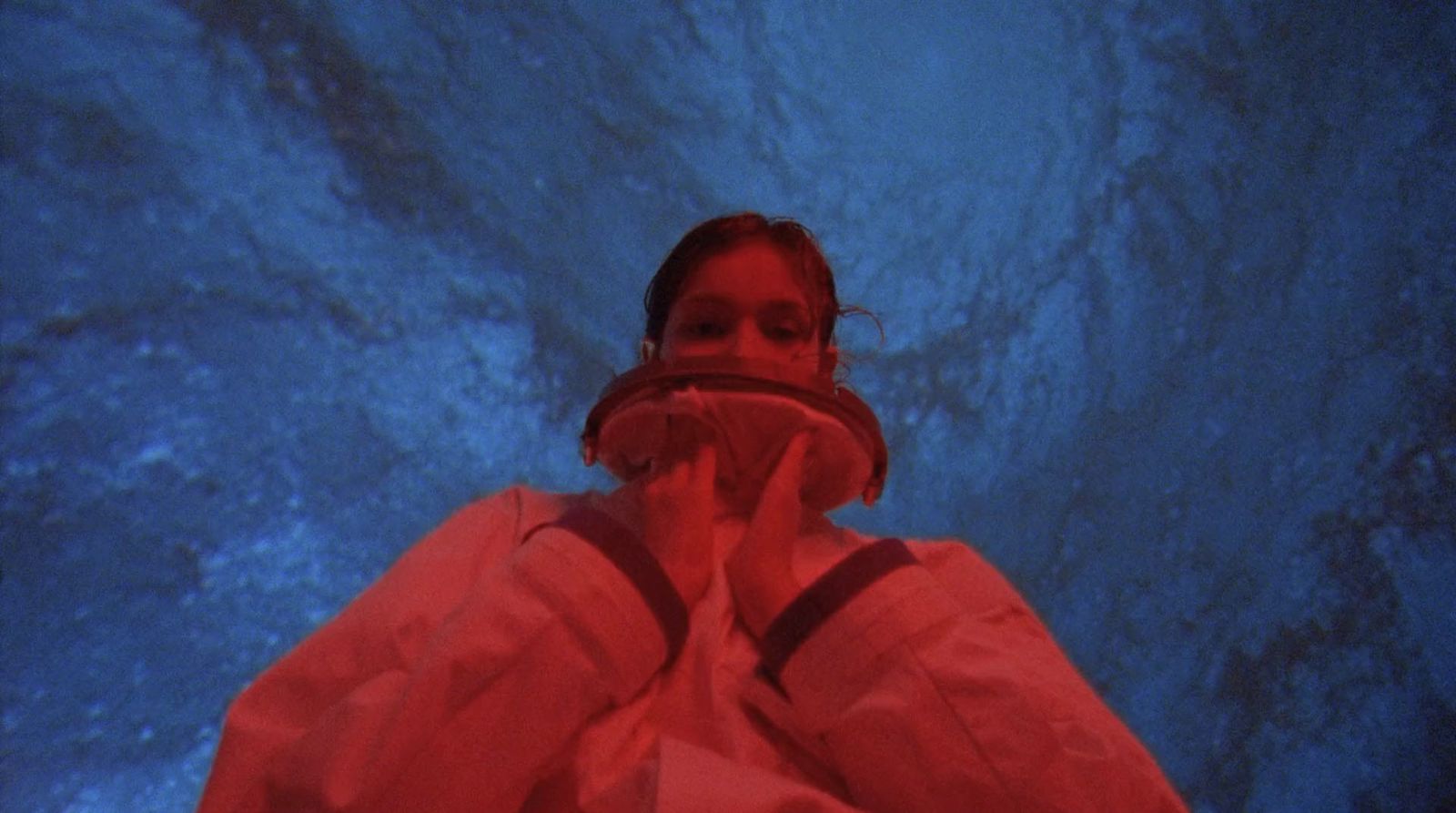 a woman standing in front of a blue background