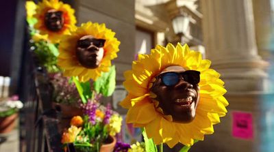 a statue of a man with sunflowers in front of him