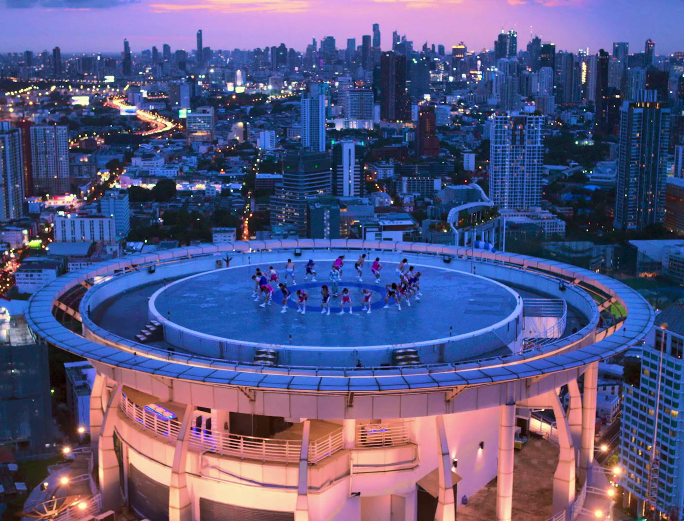 a group of people standing on top of a building