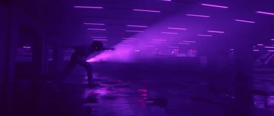 a person standing in a room with a purple light