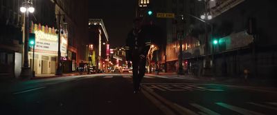 a man walking down a street at night