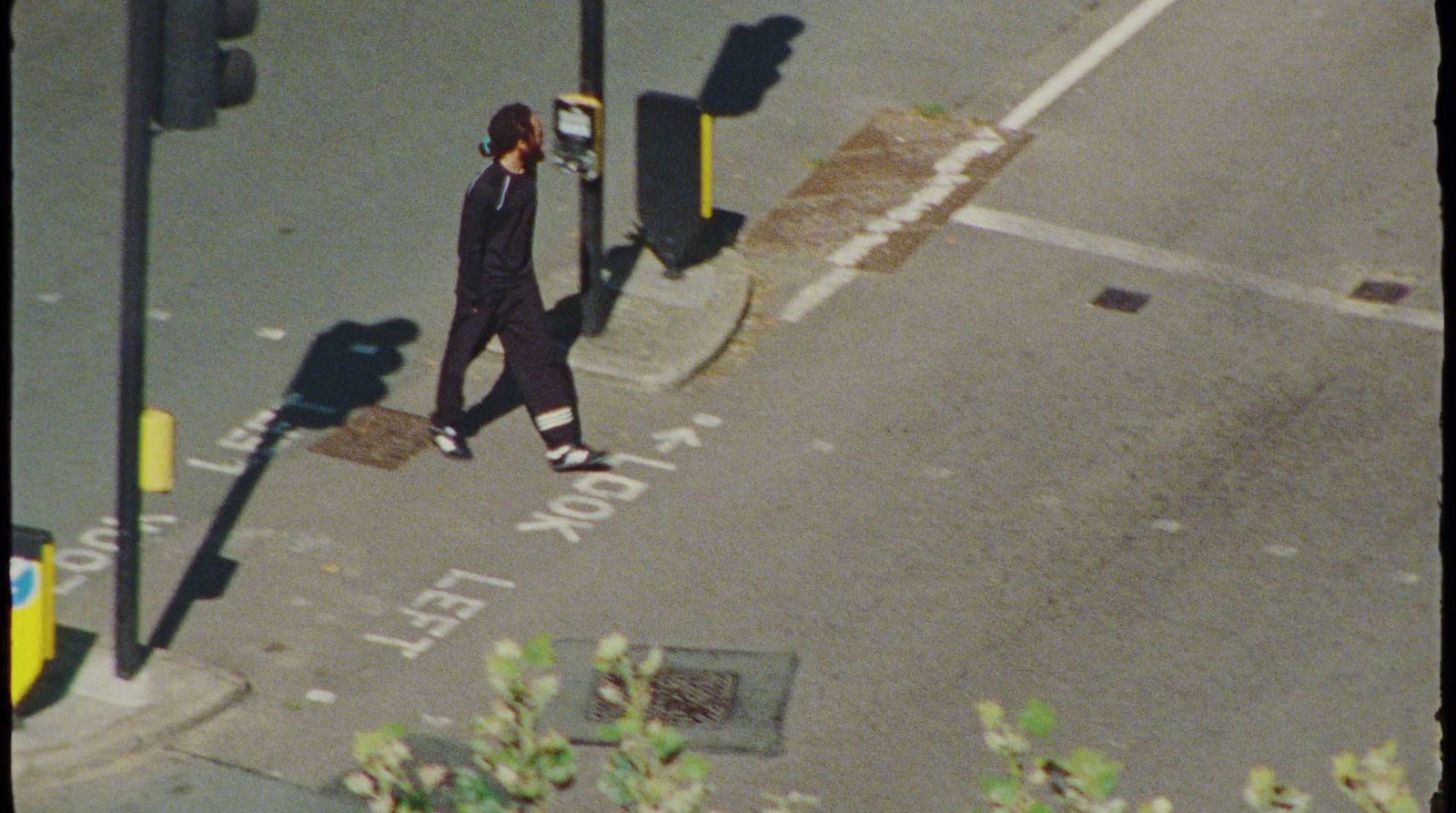 a person walking down a street talking on a cell phone