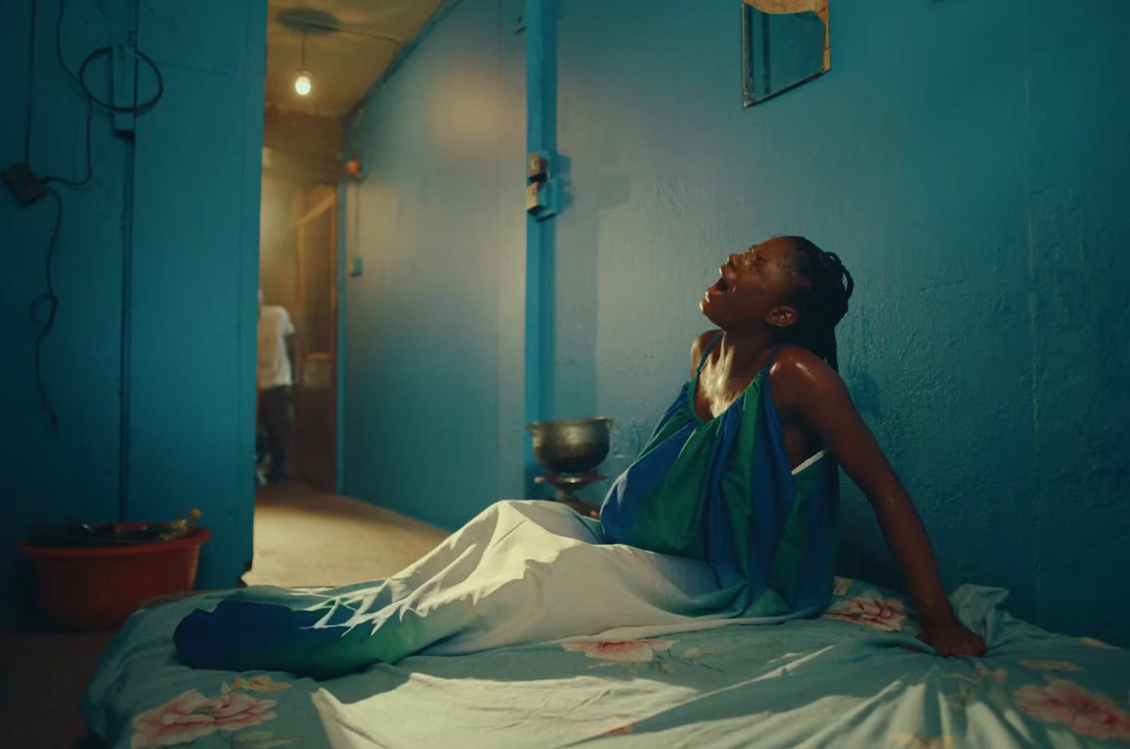 a woman sitting on a bed in a blue room