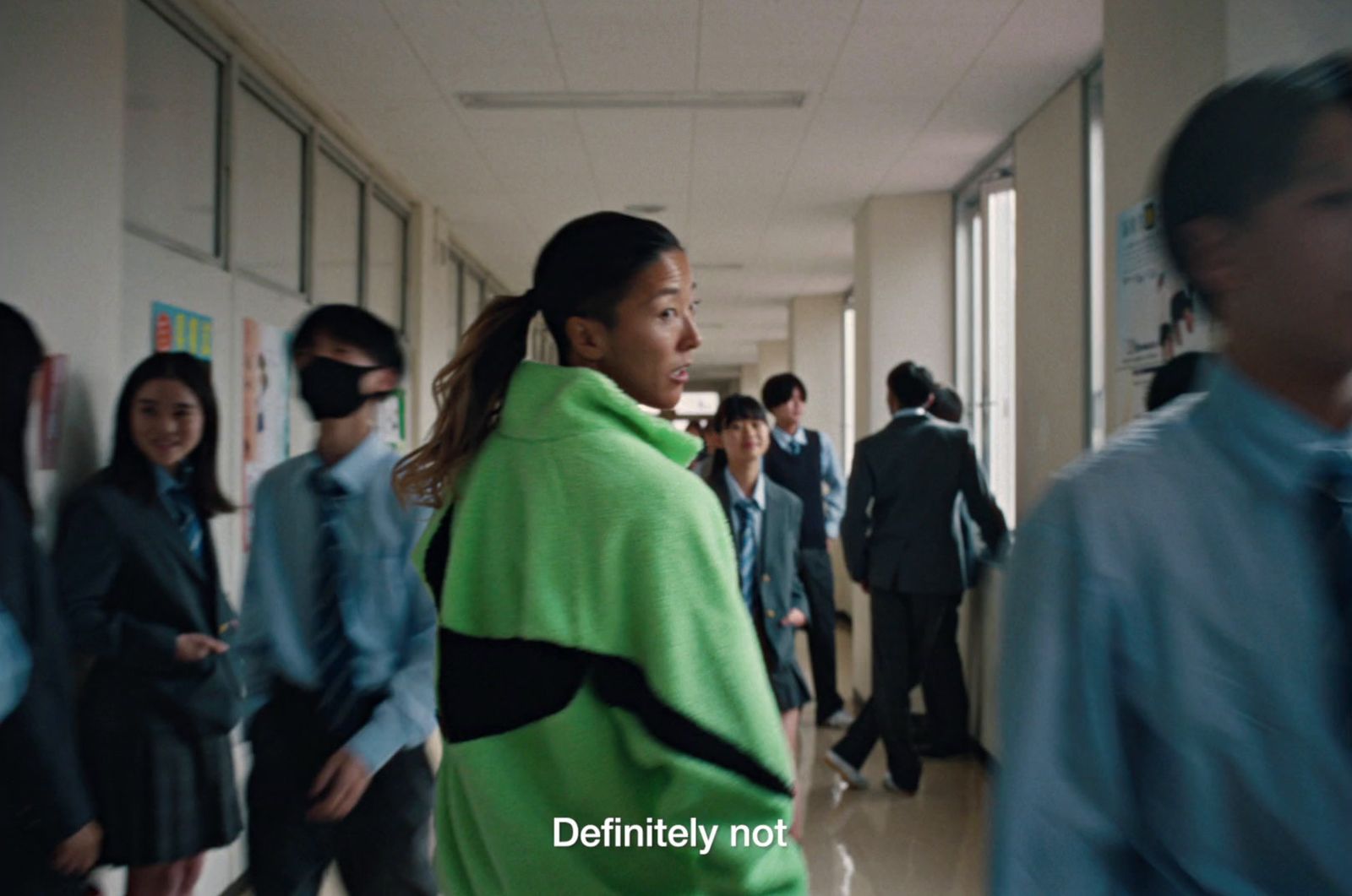 a group of people walking down a hallway