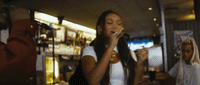 a woman standing in front of a microphone