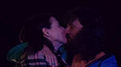 a man and a woman kissing in the dark