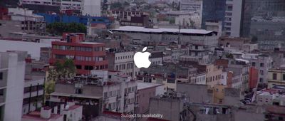 an apple logo on a building in a city