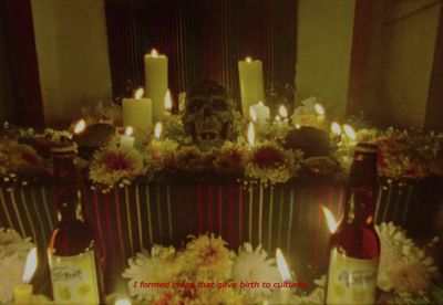 a table topped with bottles of wine and candles