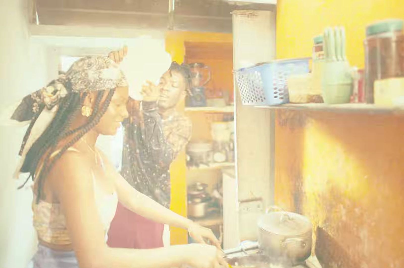 a couple of women standing in a kitchen preparing food