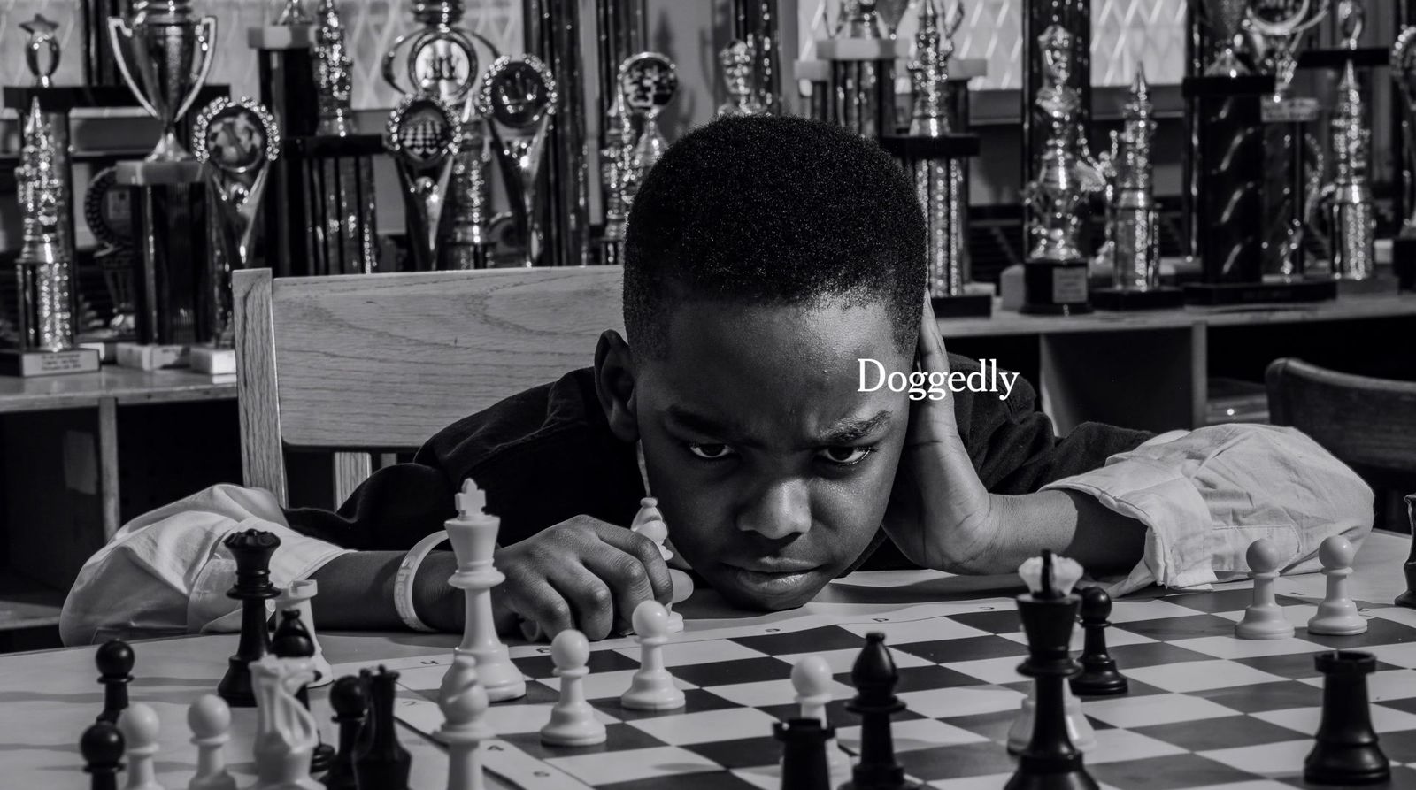 a man sitting at a table playing chess