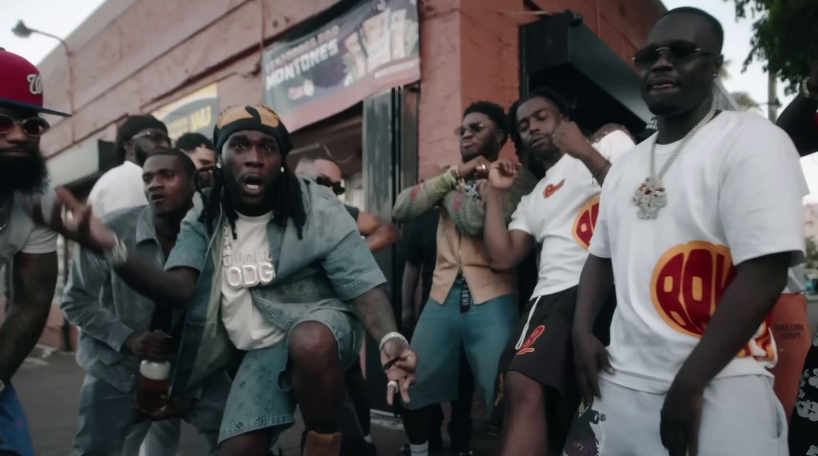 a group of men standing next to each other on a street