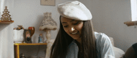 a woman wearing a white hat in a room