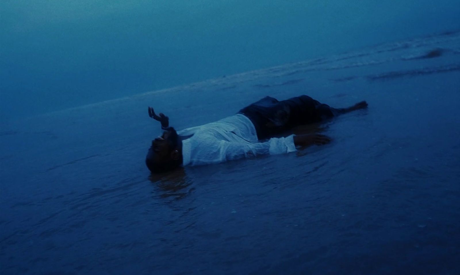 a man laying on his back in the water