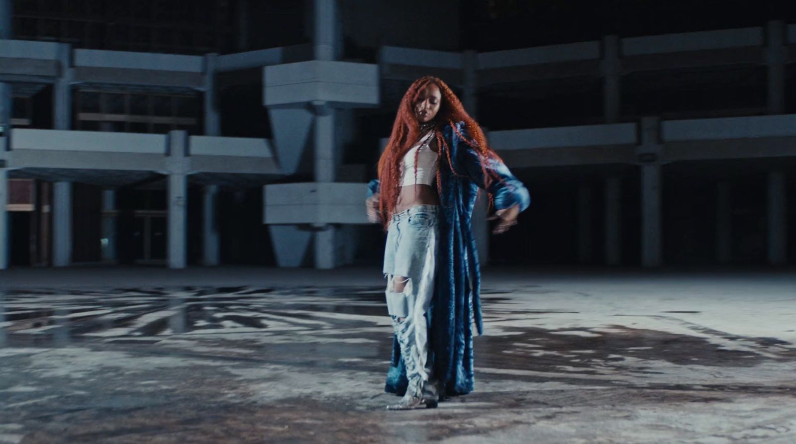 a woman with red hair standing in a building