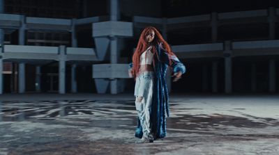 a woman with red hair standing in a building