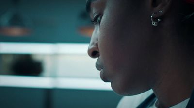 a close up of a person wearing a suit and tie