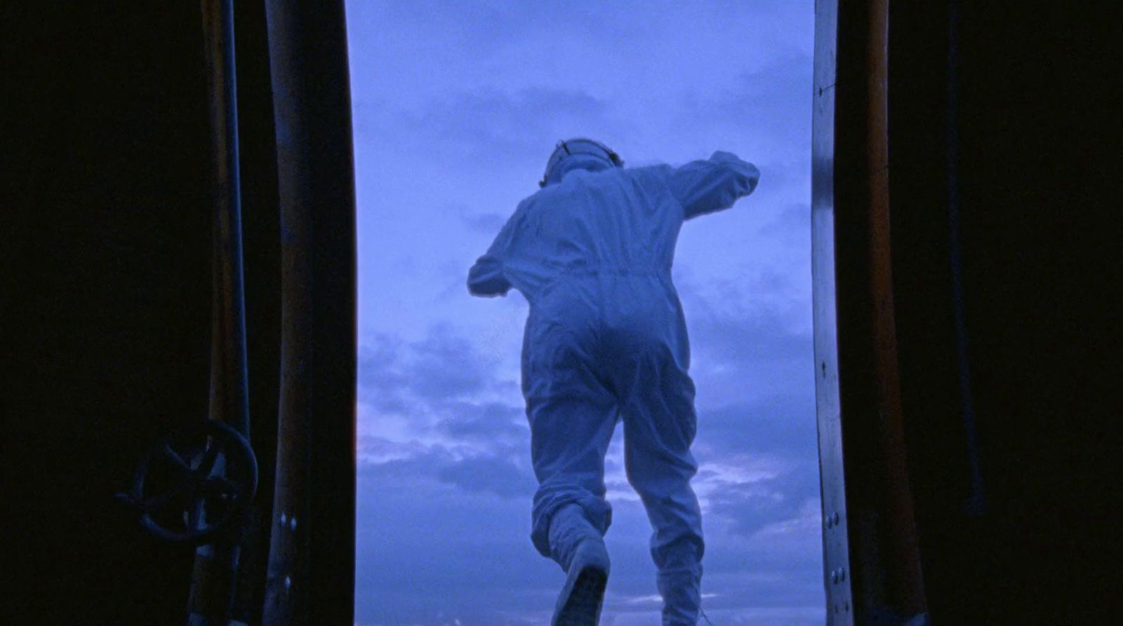 a statue of a man standing in front of a window