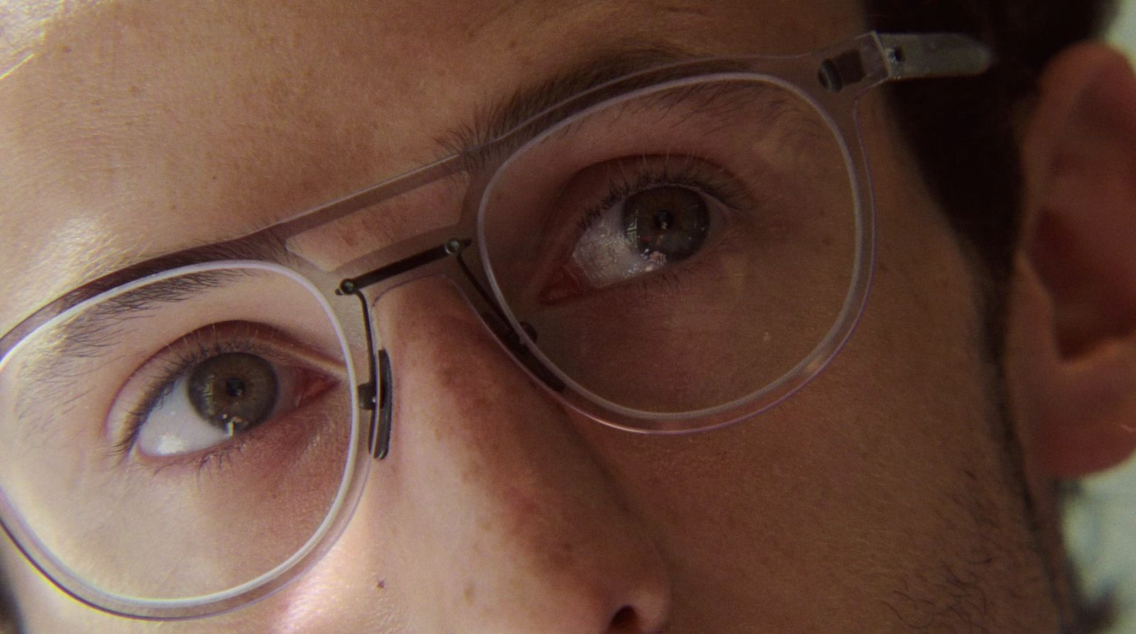 a close up of a person wearing glasses