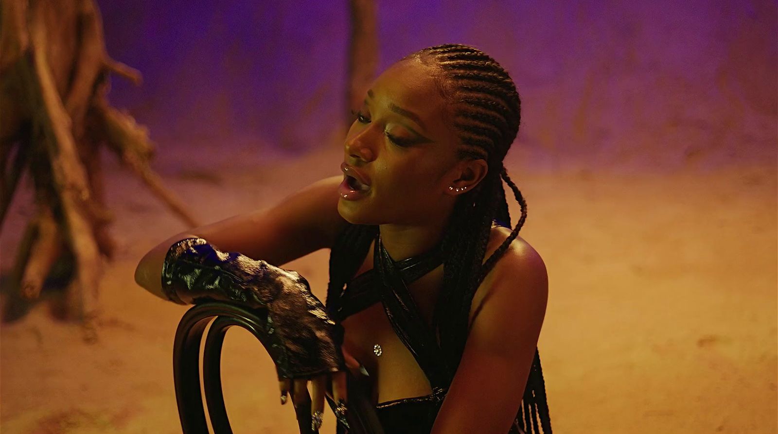 a woman with dreadlocks sitting on a chair