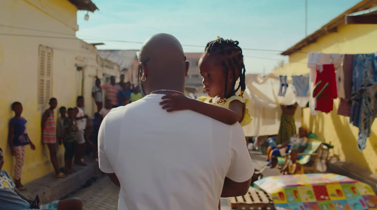 a man holding a little girl in his arms