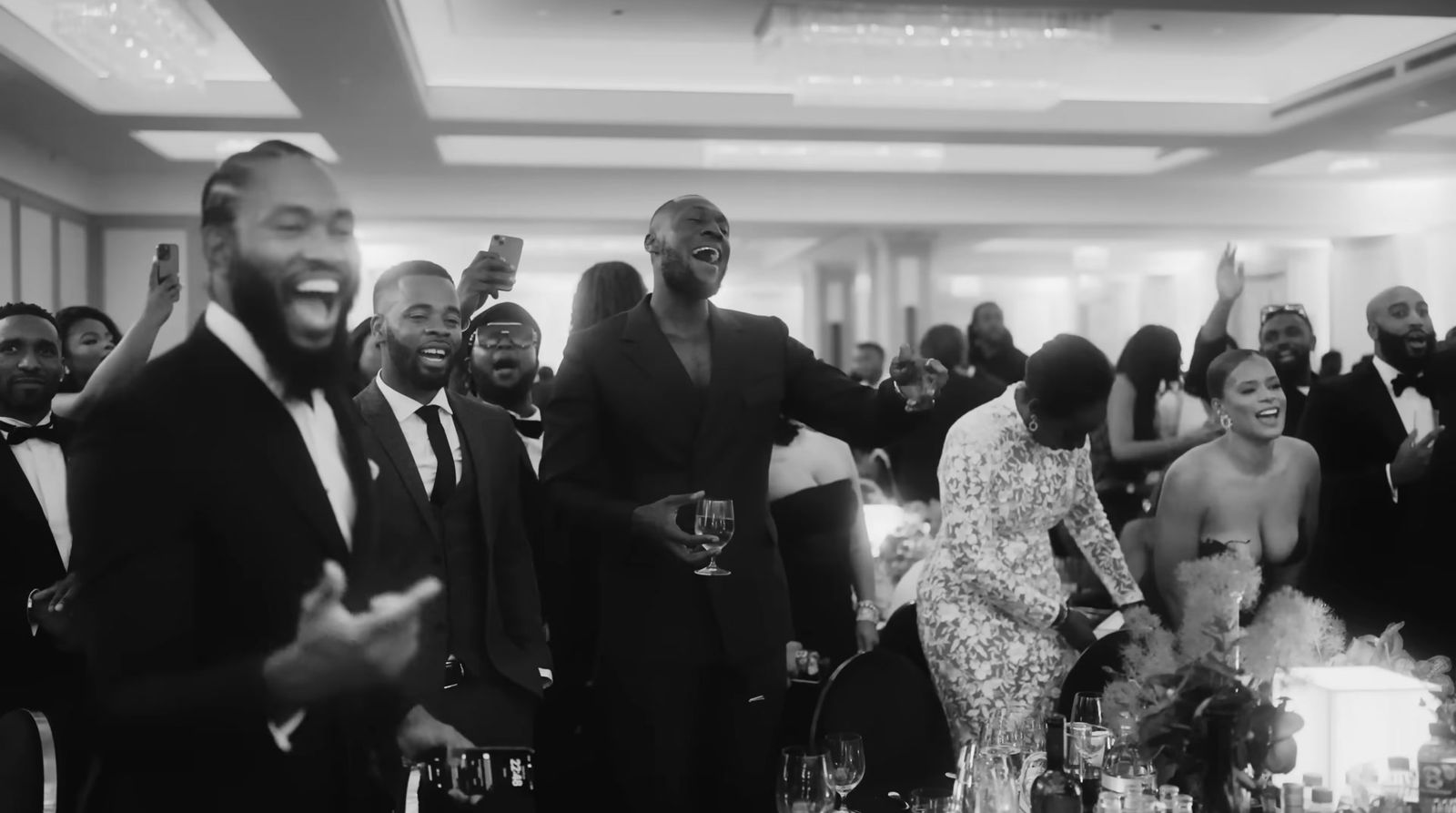 a group of people standing around each other at a party