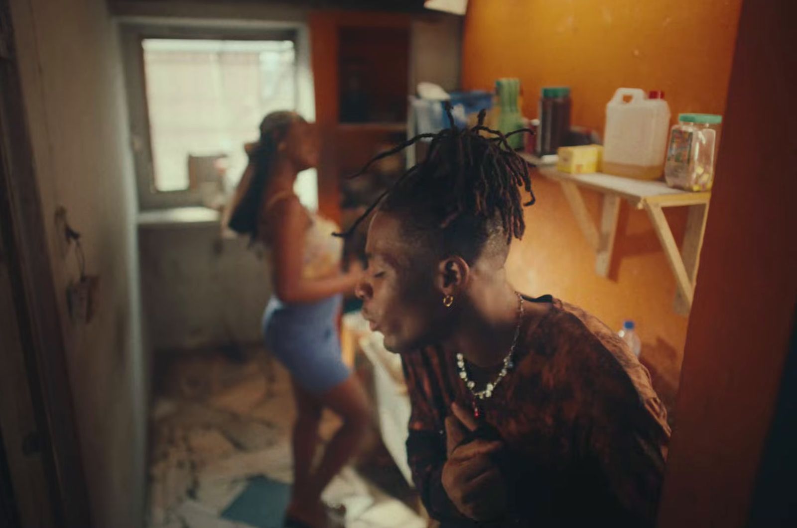 a woman standing in a kitchen next to another woman