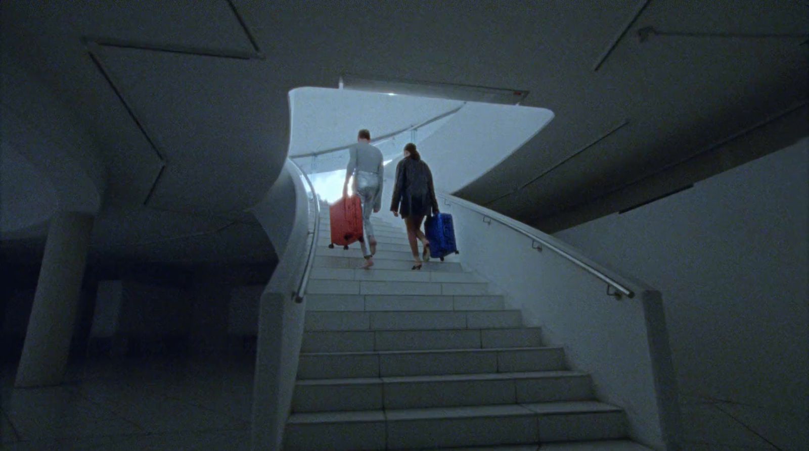 a couple of people walking down a flight of stairs