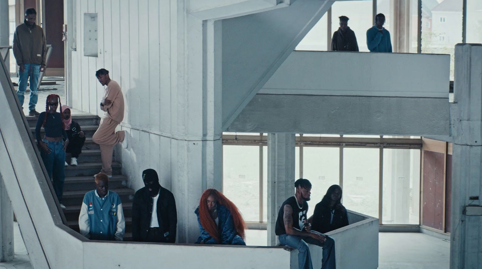 a group of people sitting on the stairs of a building