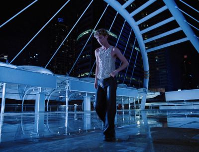 a man standing in front of a white piano