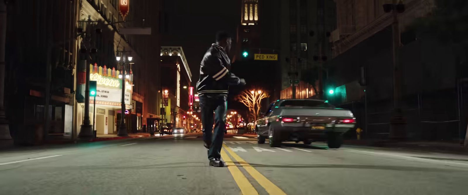 a man riding a skateboard down a street at night