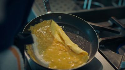 a frying pan filled with food on top of a stove