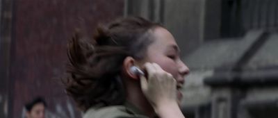 a woman talking on a cell phone while standing in front of a building