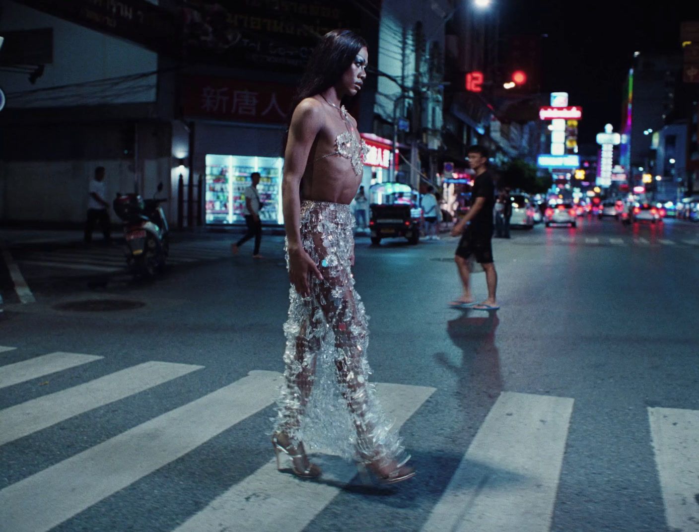 a man standing in the middle of a street at night