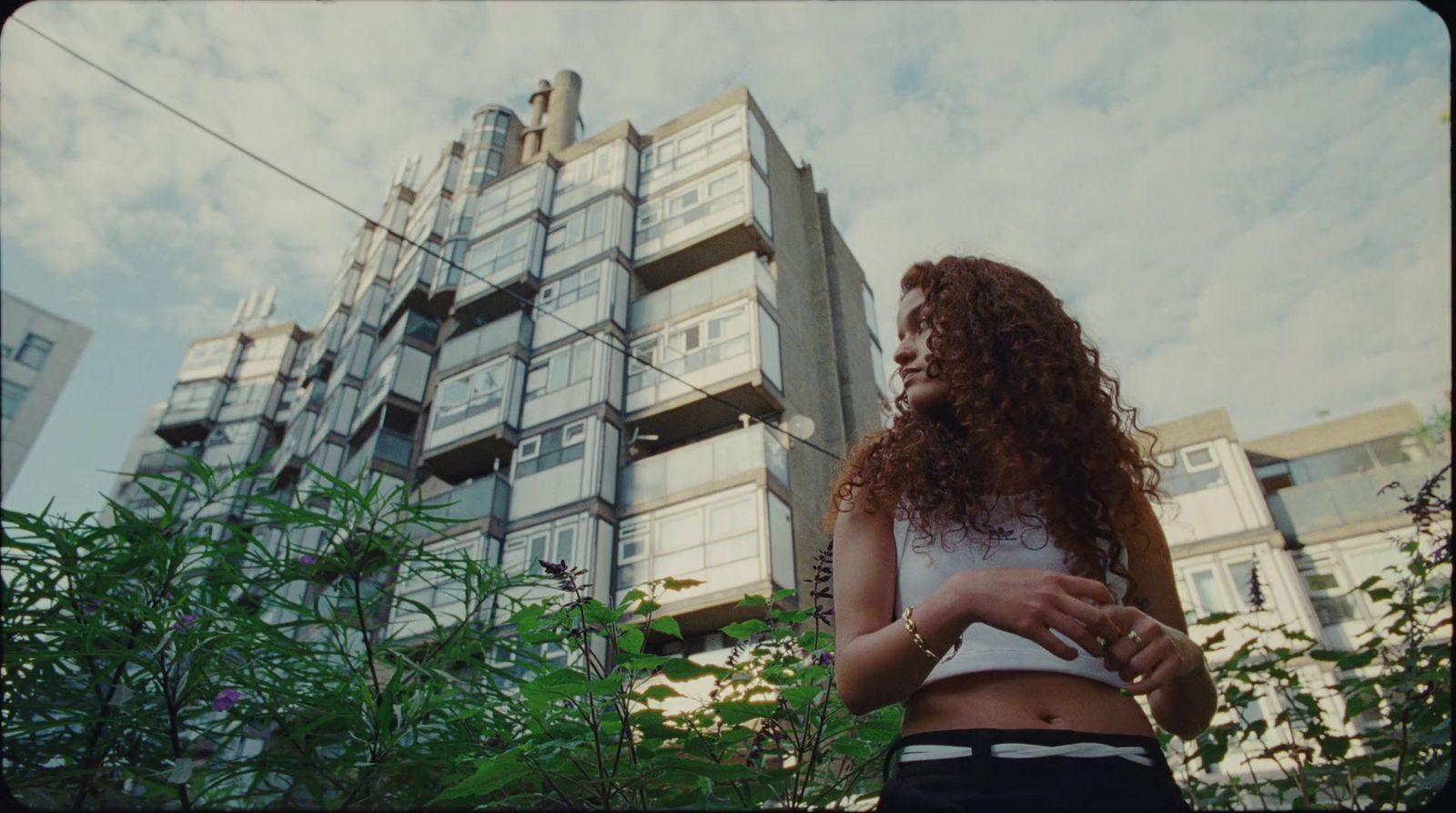 a woman standing in front of a tall building