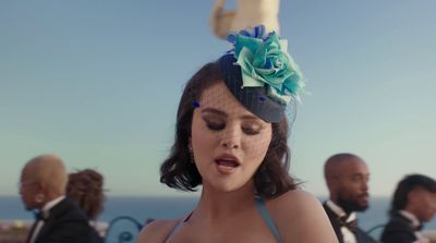 a woman wearing a hat with a flower on it