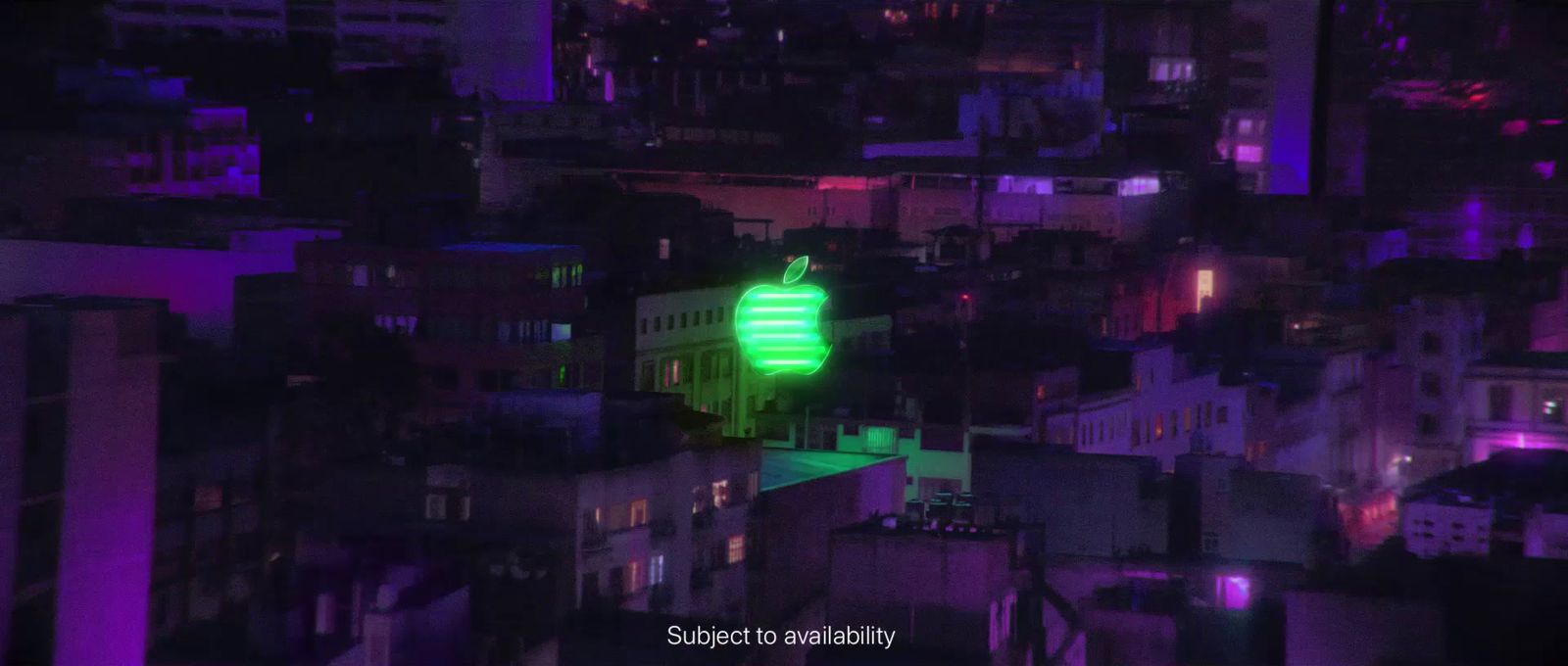 a green light on top of a building in a city