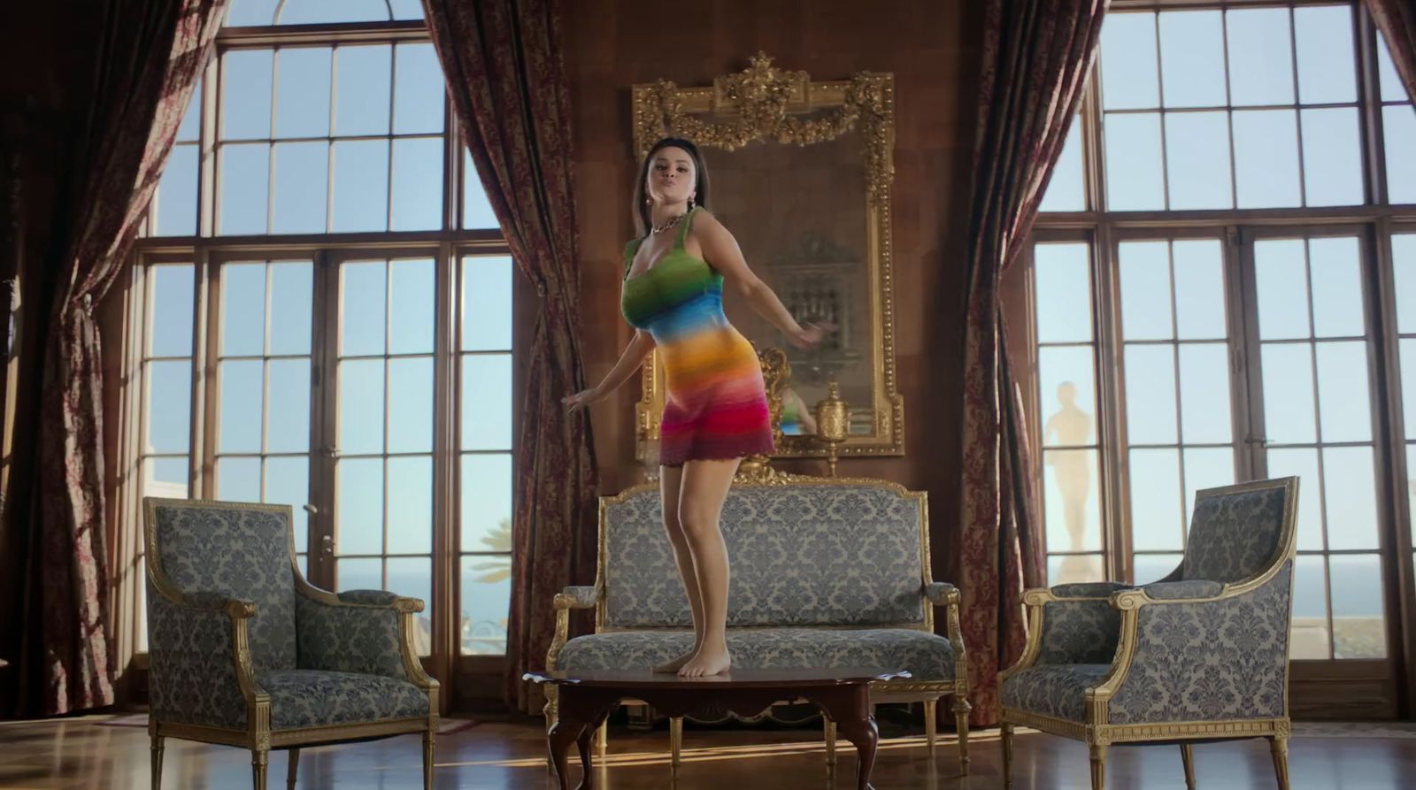 a woman in a colorful dress standing in a living room