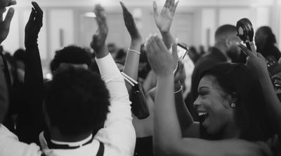 a group of people raising their hands in the air