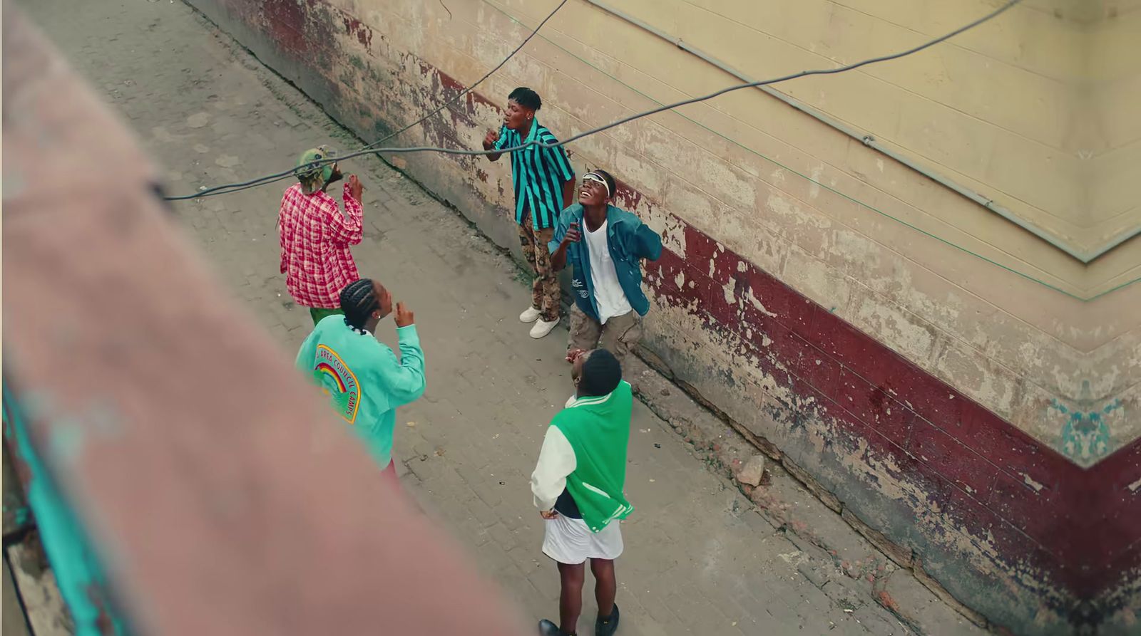 a group of people standing on the side of a building