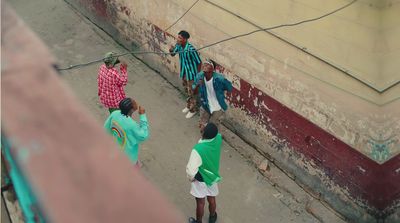 a group of people standing on the side of a building