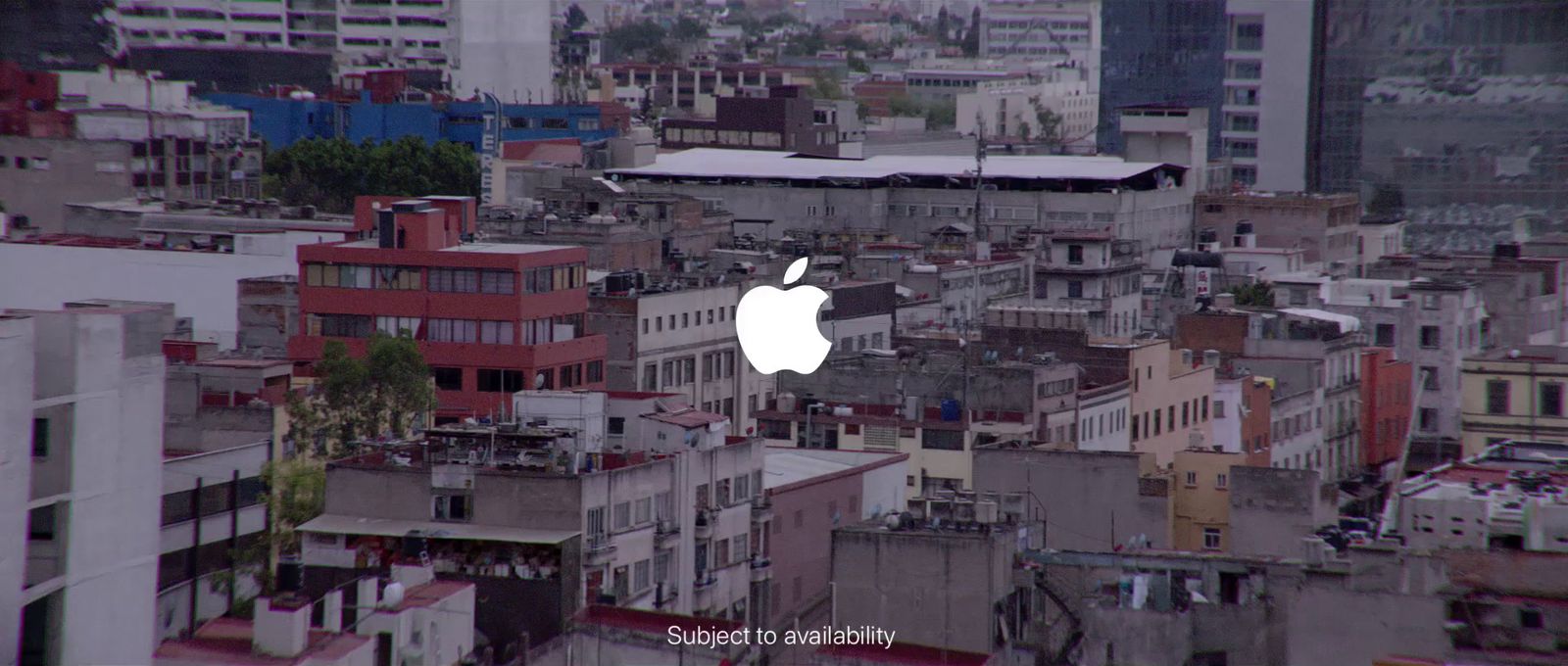 an apple logo on a building in a city