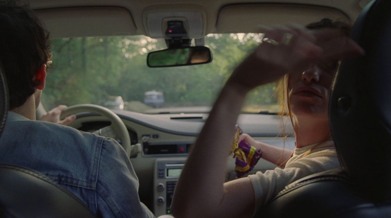 a man and a woman sitting in a car