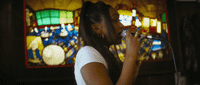 a woman standing in front of a stained glass window